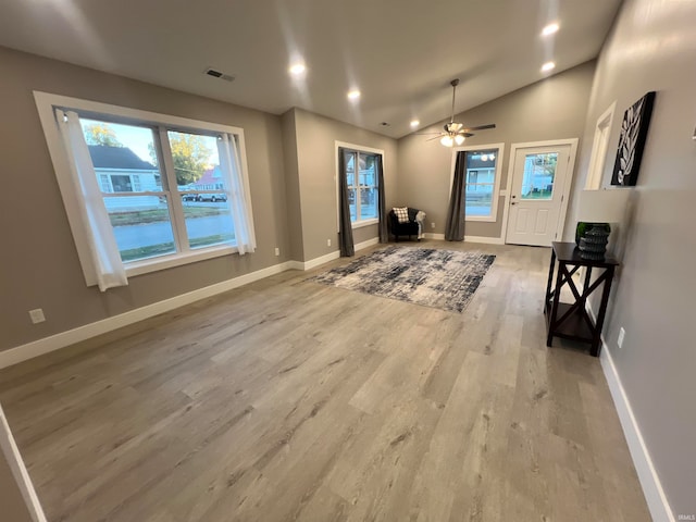 foyer entrance featuring lofted ceiling, light wood-type flooring, and ceiling fan