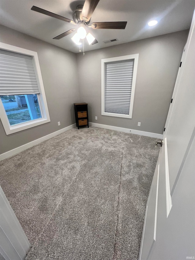 unfurnished room featuring carpet flooring and ceiling fan