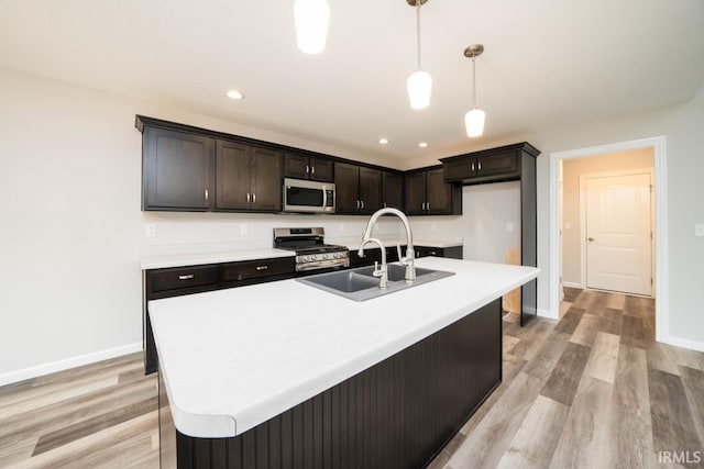 303 Renee Way, Albion, IN 46701 - kitchen with baseboards, stainless steel appliances, light wood-type flooring, and a sink