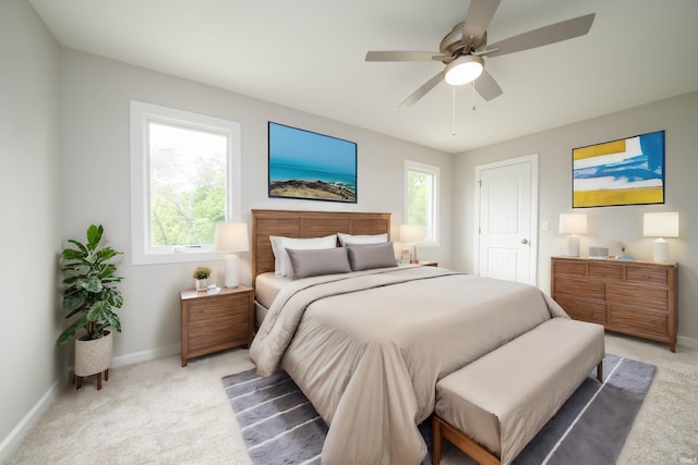 bedroom with ceiling fan and light carpet