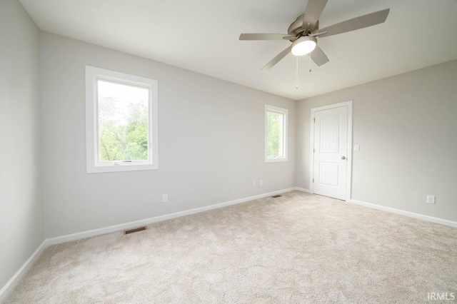 spare room with carpet and ceiling fan