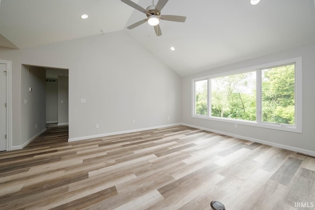 unfurnished room with light hardwood / wood-style flooring, high vaulted ceiling, and ceiling fan