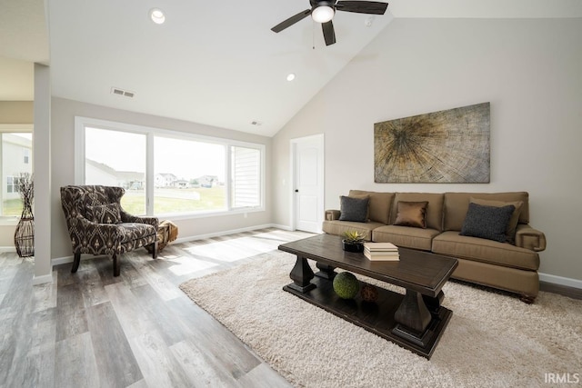 living room with high vaulted ceiling, light wood-type flooring, and ceiling fan