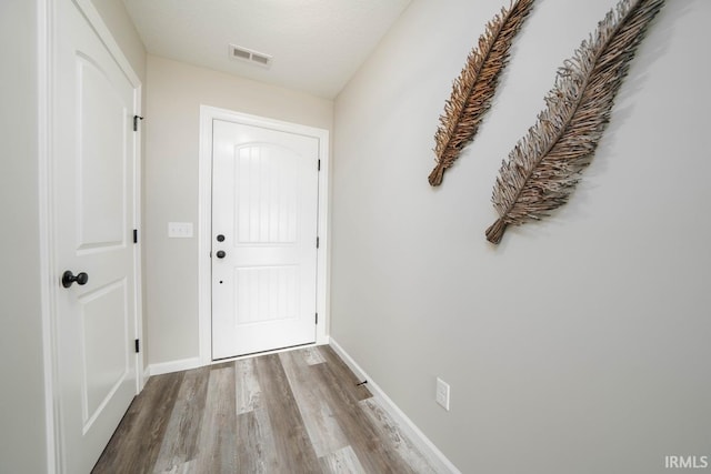 entryway featuring a textured ceiling and light hardwood / wood-style floors