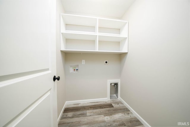 clothes washing area featuring light hardwood / wood-style floors, washer hookup, and hookup for an electric dryer