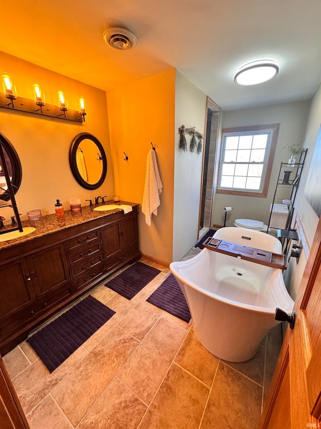 bathroom featuring vanity, a tub to relax in, and tile patterned floors