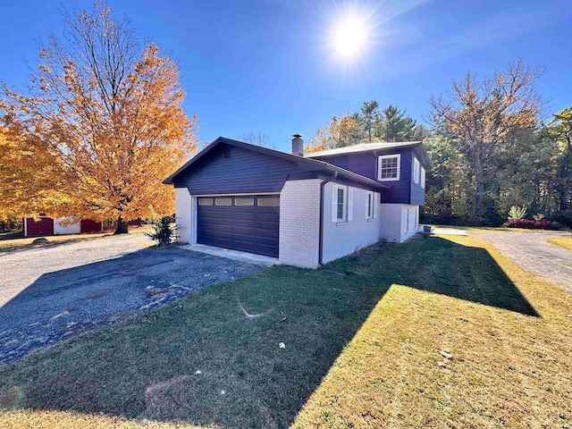 view of property exterior with a yard and a garage