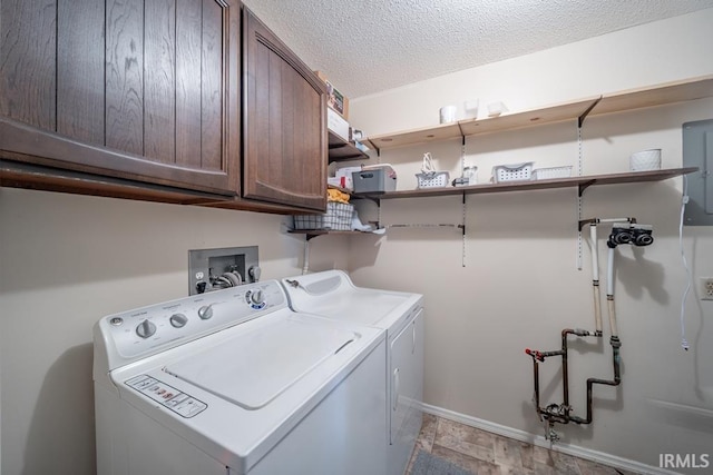 laundry area featuring electric panel, a textured ceiling, cabinets, and washer and clothes dryer