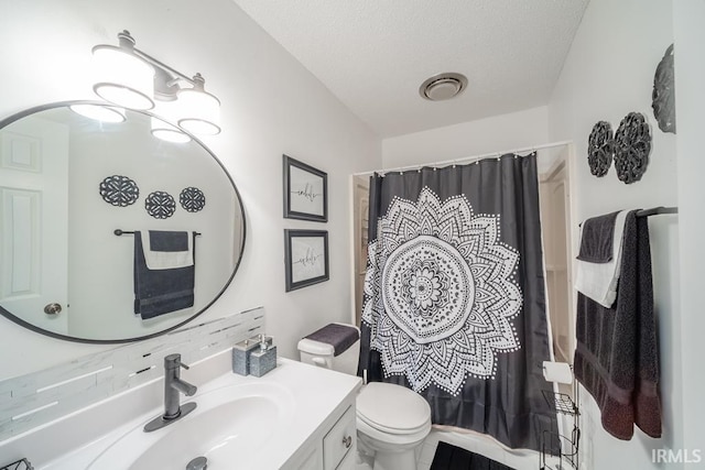 bathroom featuring vanity, a shower with shower curtain, a textured ceiling, and toilet