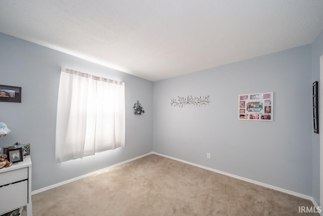 unfurnished room featuring light carpet