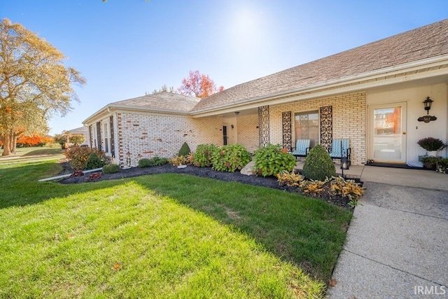 4501 N Wheeling Ave Unit 5-1A, Muncie, IN 47304 - view of front of home with a front yard, a porch, and brick siding