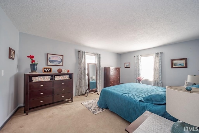 bedroom with light carpet and a textured ceiling