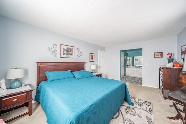 carpeted bedroom featuring ensuite bath