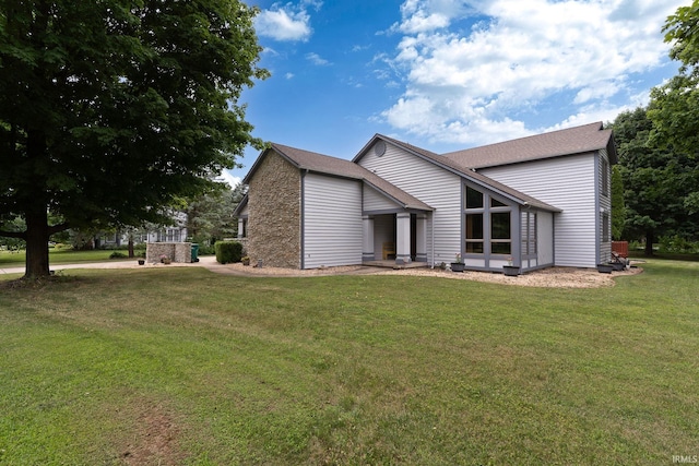 rear view of property with a lawn