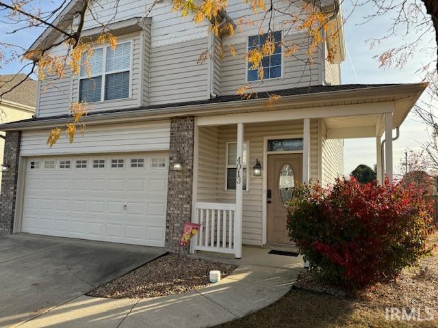 view of front of home with a porch and a garage