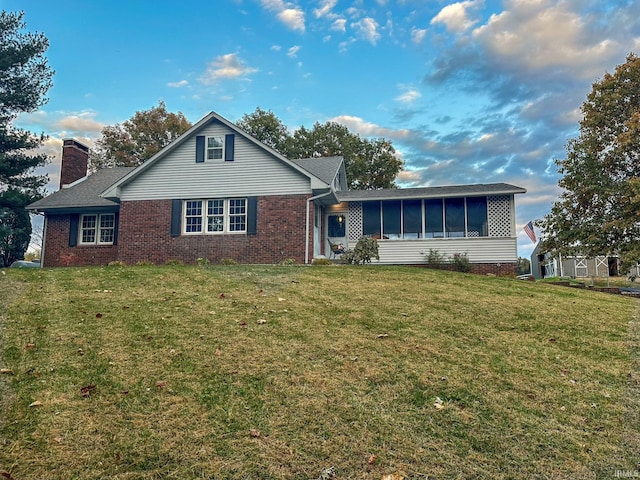 view of front property featuring a front lawn and a sunroom