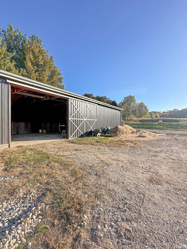 view of outdoor structure with a rural view