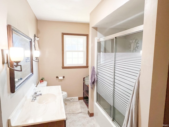 full bathroom featuring bath / shower combo with glass door, vanity, and toilet