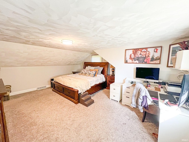 bedroom with light colored carpet and lofted ceiling