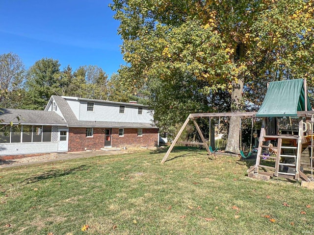 view of yard featuring a playground and a sunroom