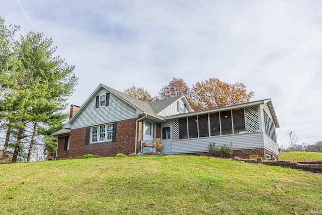 view of front facade featuring a front lawn and a sunroom