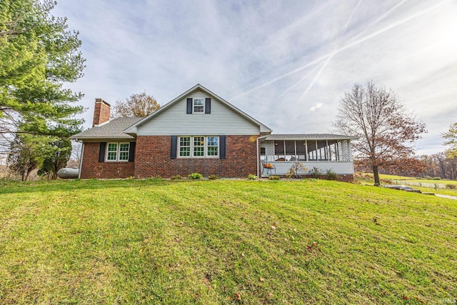 view of front of home featuring a front lawn and a sunroom