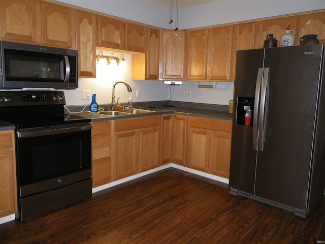 kitchen with stainless steel appliances, sink, and dark hardwood / wood-style floors