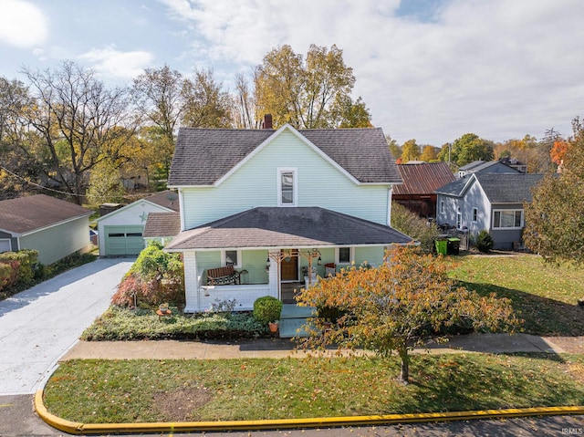 view of front of property featuring covered porch, a garage, and an outbuilding