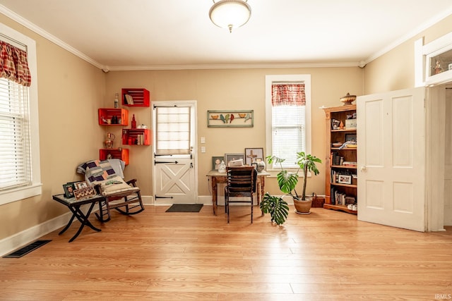 sitting room featuring crown molding and light wood-type flooring