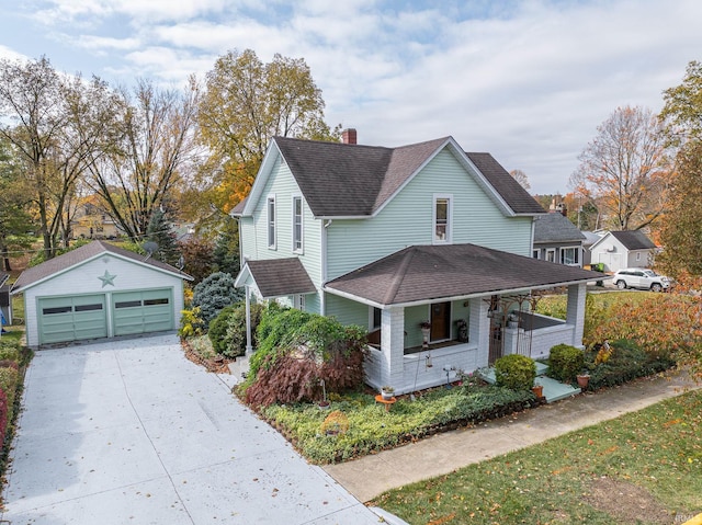 view of front of home featuring covered porch, a garage, and an outbuilding