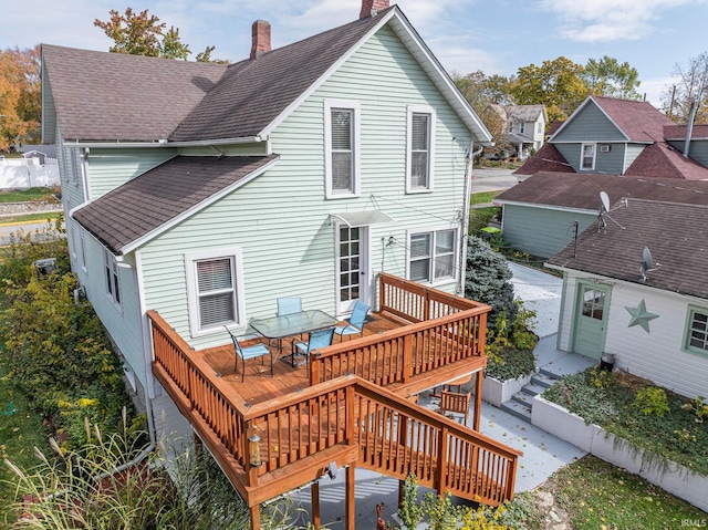 rear view of house featuring a deck