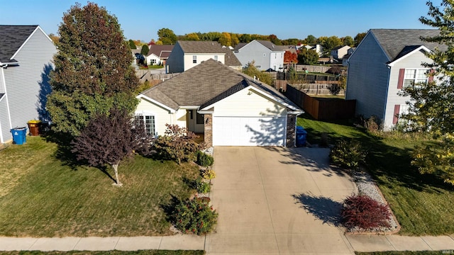 view of front of house with a front yard and a garage