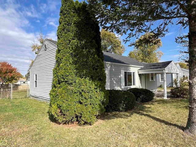 view of side of home with a yard