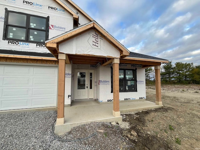 doorway to property with a garage