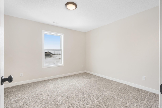 empty room featuring a textured ceiling and carpet floors