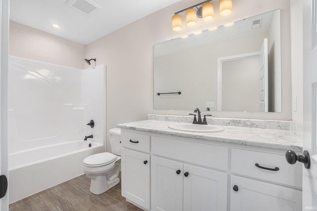 full bathroom featuring tub / shower combination, wood-type flooring, vanity, and toilet