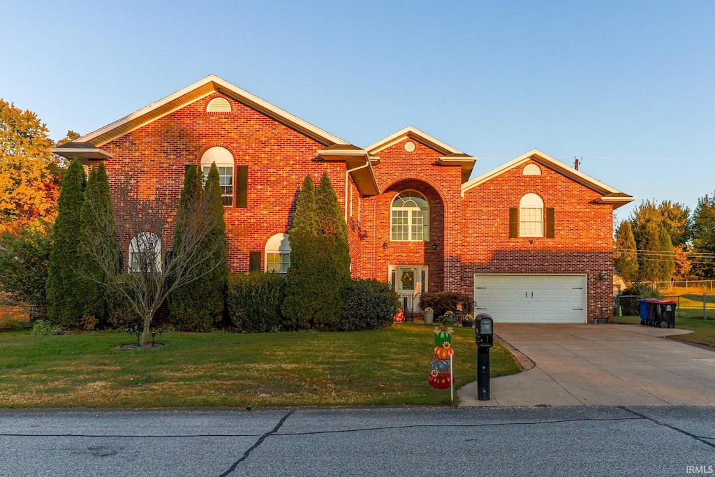 view of property featuring a front yard and a garage