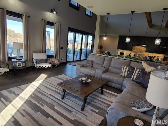 living room with beam ceiling and high vaulted ceiling