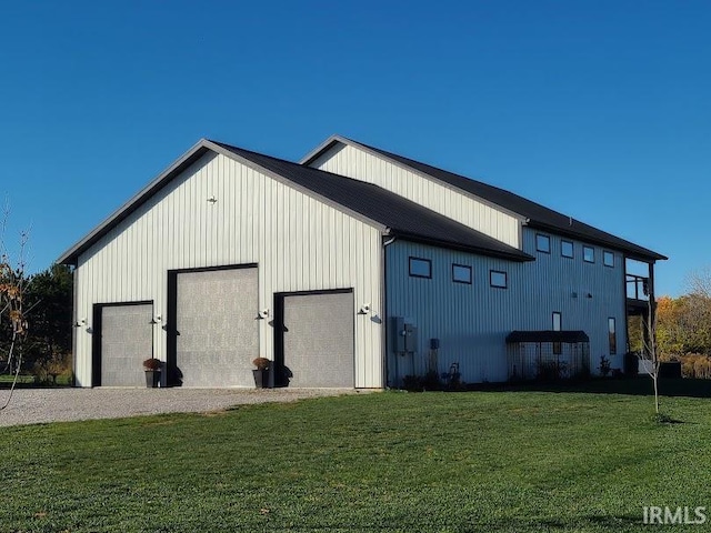 view of outbuilding with a yard and a garage