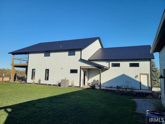 rear view of property with a yard