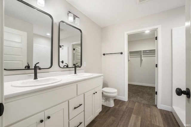 bathroom with vanity, toilet, and hardwood / wood-style floors