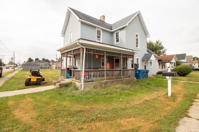 view of front of property with a front yard and a porch