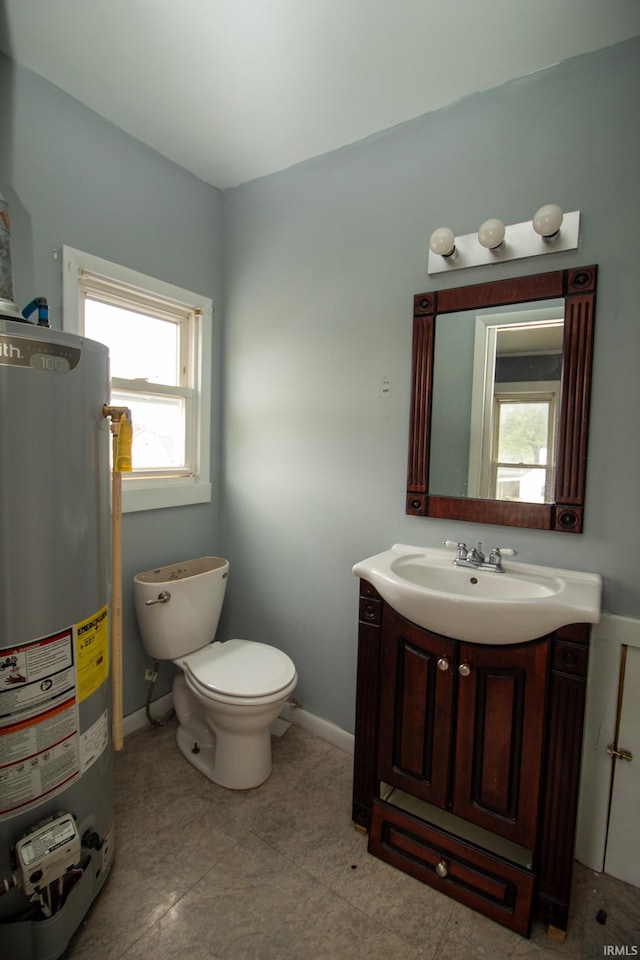 bathroom featuring vanity, toilet, tile patterned floors, and gas water heater