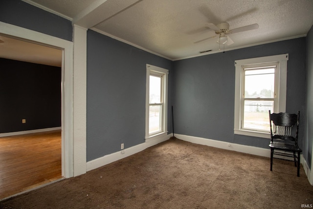 carpeted empty room with ornamental molding, a textured ceiling, and ceiling fan