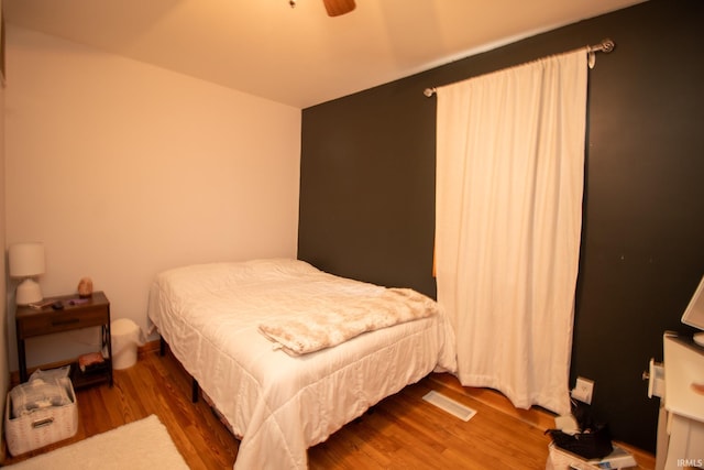 bedroom featuring hardwood / wood-style floors and ceiling fan