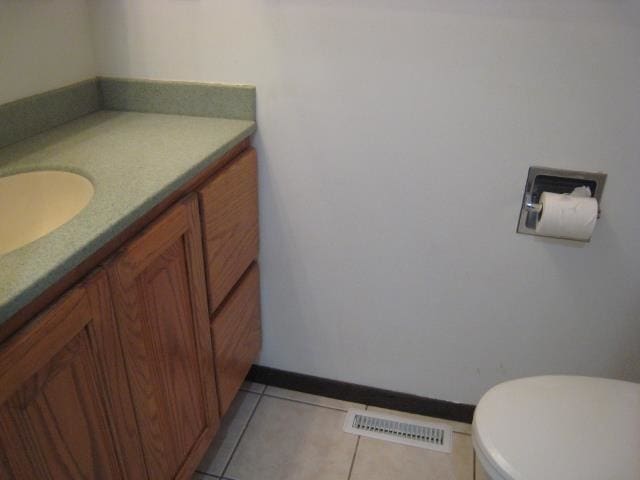 bathroom with vanity, toilet, and tile patterned flooring