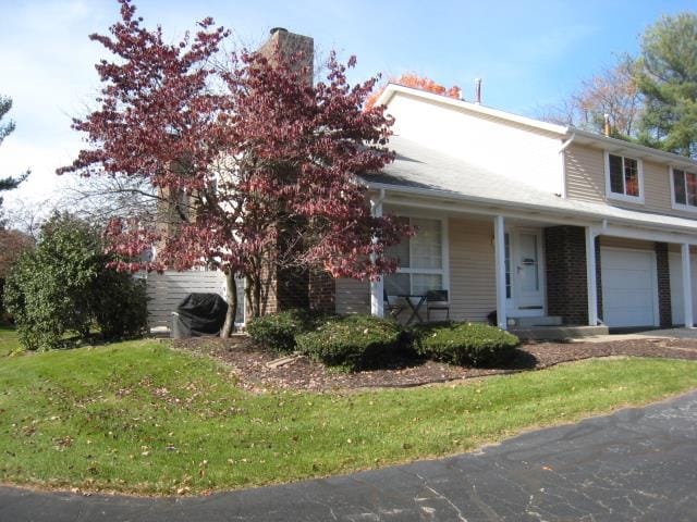 view of front of house with a front lawn and a garage