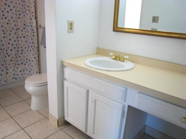 bathroom featuring vanity, a shower with shower curtain, toilet, and tile patterned flooring