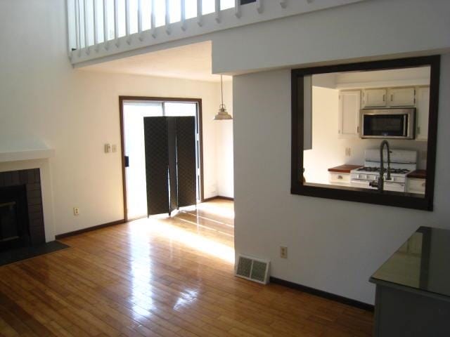 unfurnished living room featuring wood-type flooring