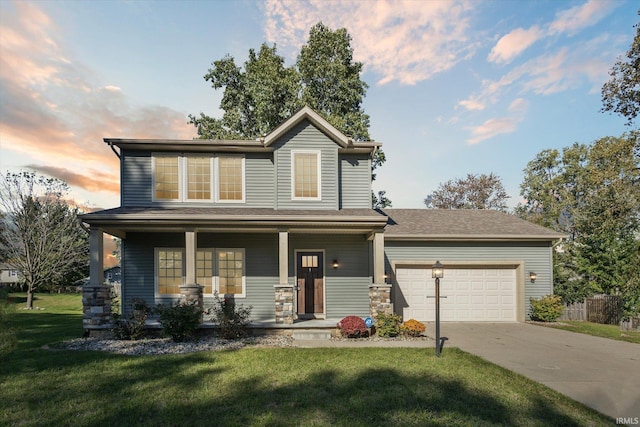 view of front facade featuring a yard, a garage, and a porch